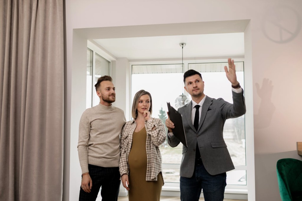 Real estate agent showing a property to clients